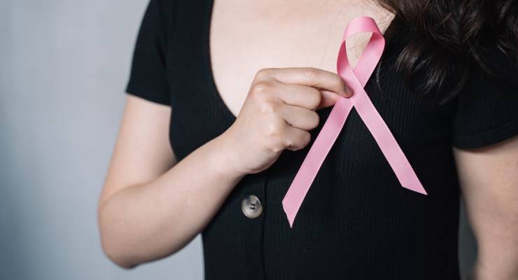 breast cancer ribbon woman holding in hand