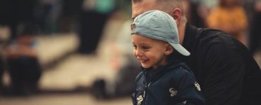child laughing with father cancer